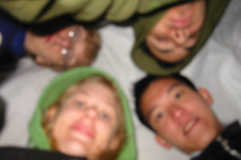 A very blurry photo of myself and three friends waiting under a tarp for George Lucas.